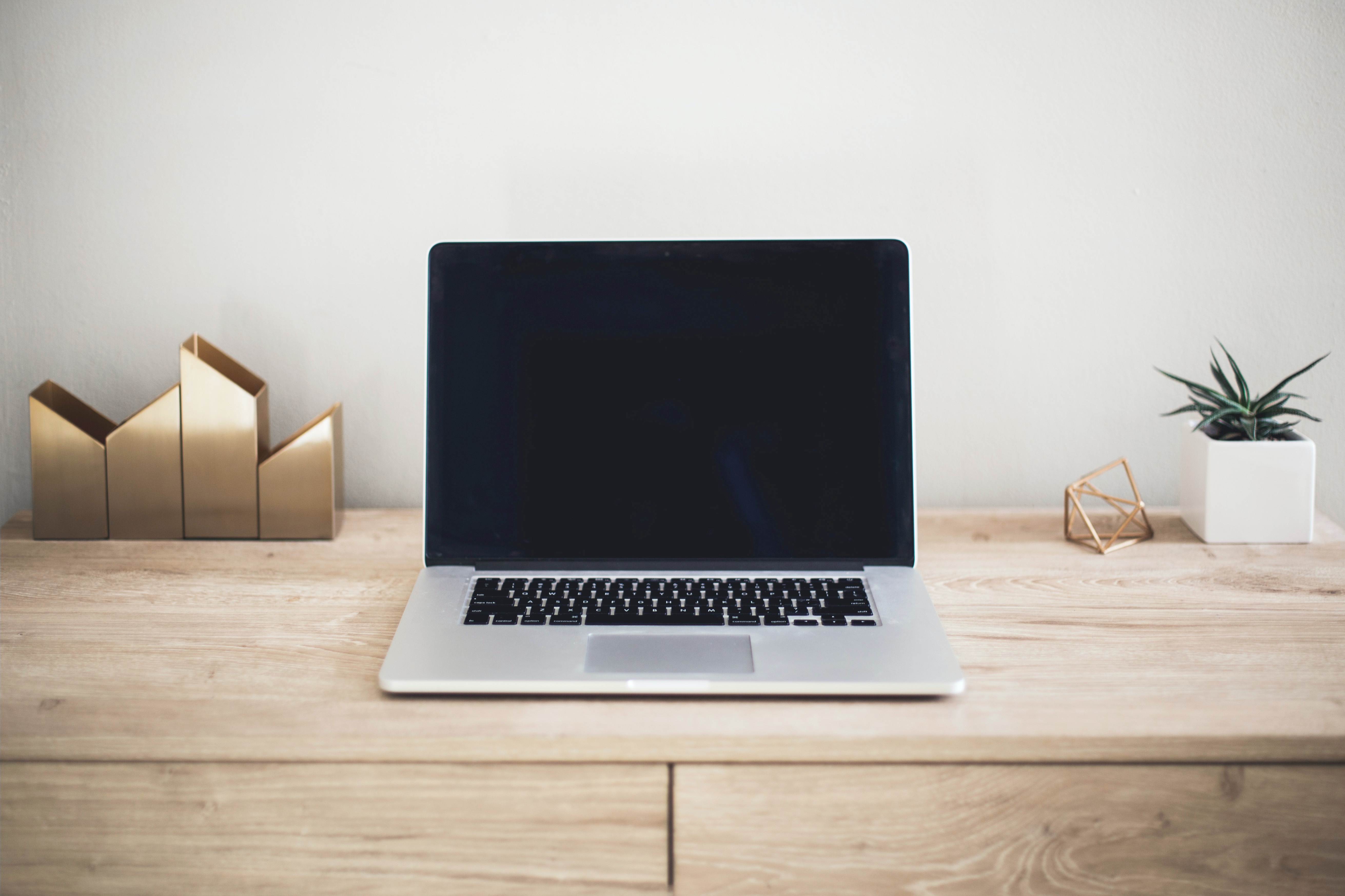 a laptop sitting on the wood